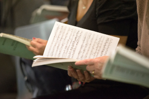 Choir members reading music